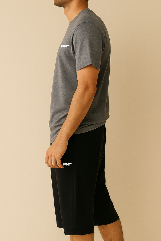 side view of Men wearing a grey cotton shirt with black shorts for a causal outfit