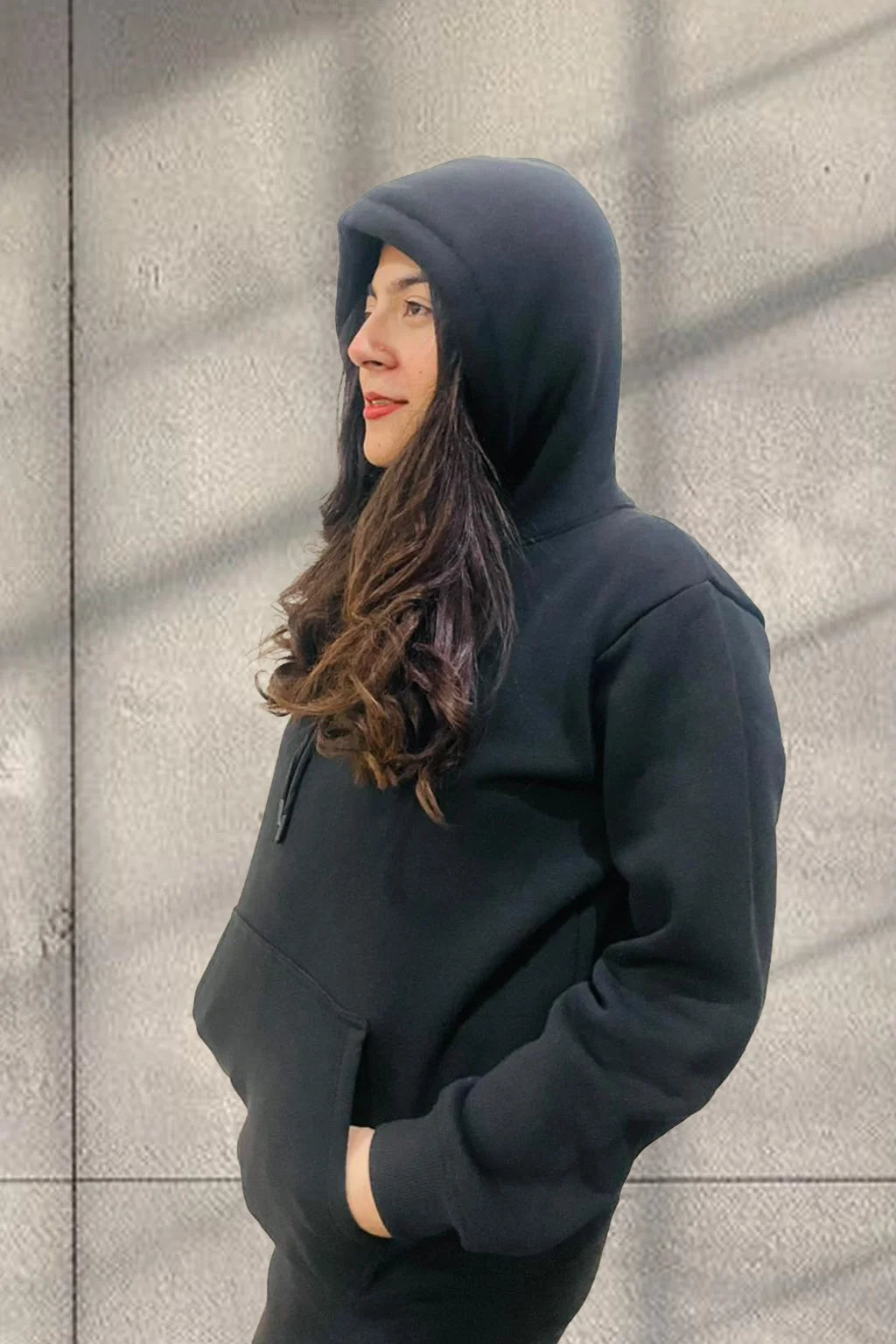 Side view of Women wearing a Black Hoodie Pullover & Jogger Set in Fleece