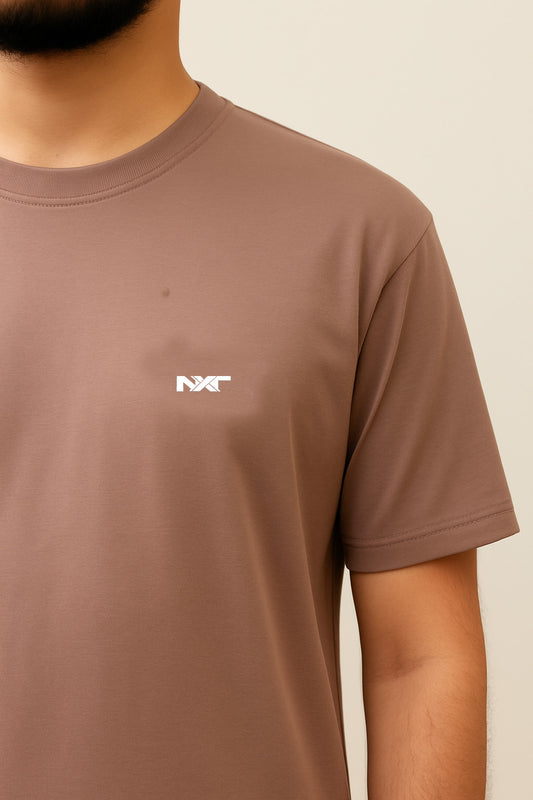 Close-up of Nxtwears logo on men’s brown cotton T-shirt – premium summer shirt fabric