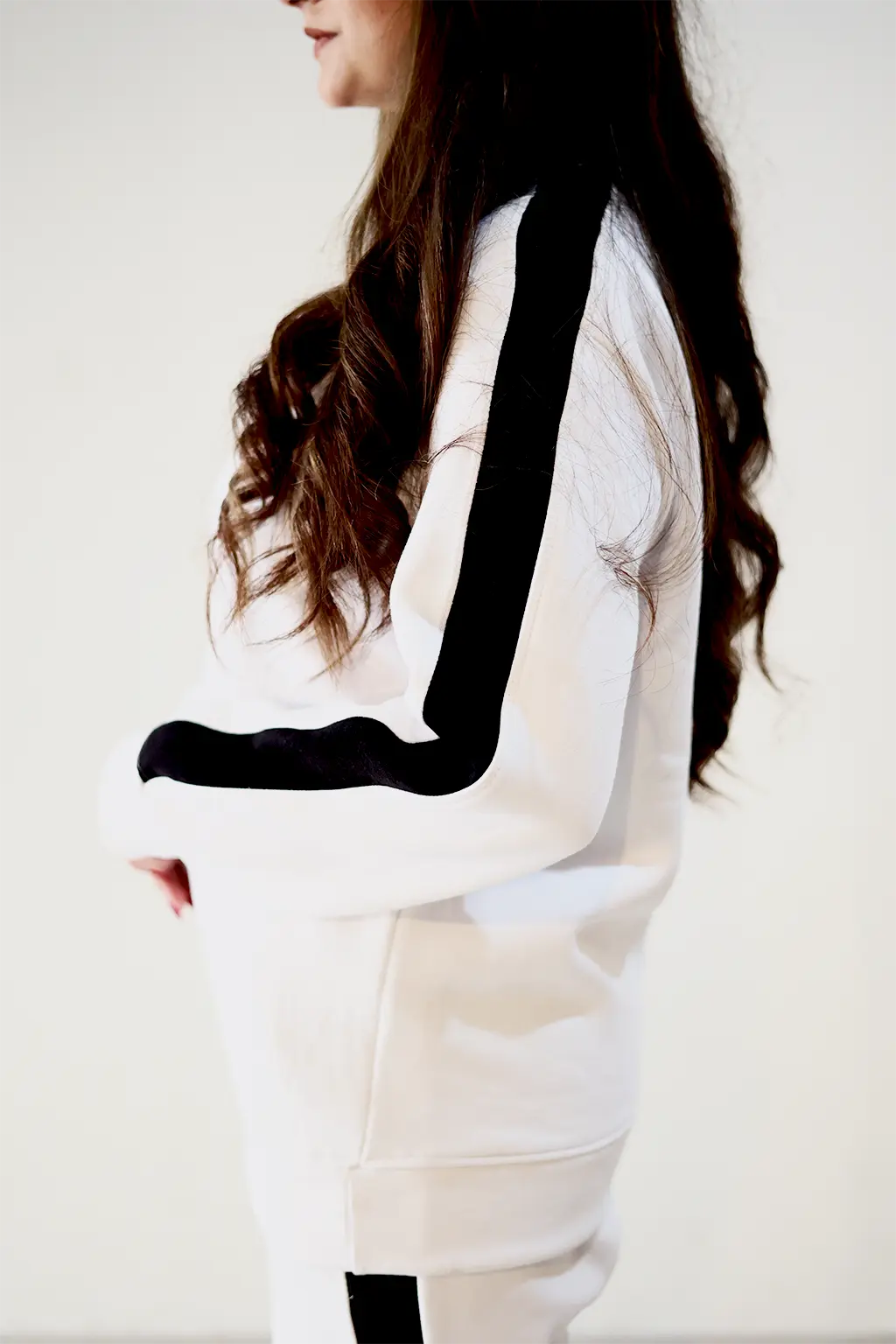 Model wearing Nxtwears white unisex sweatsuit with black stripes