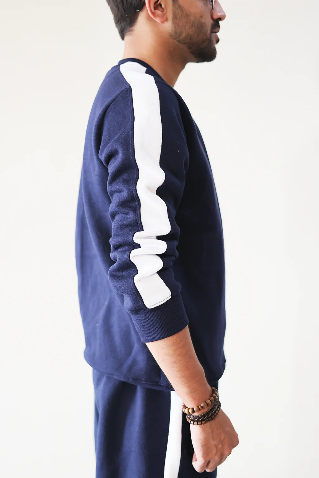 Side view of Nxtwears navy blue unisex sweatsuit with contrasting white stripe detailing for men and women