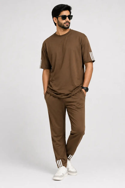 Man wearing a brown outfit with white stripes on a white background