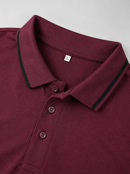 Maroon polo shirt with black trim on a light gray background
