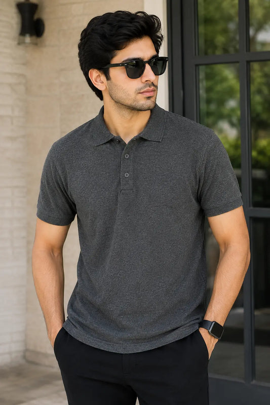 Man wearing a Charcoal grey polo shirt and sunglasses outdoors.