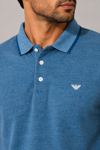 Blue polo shirt with a brand logo on a gray background