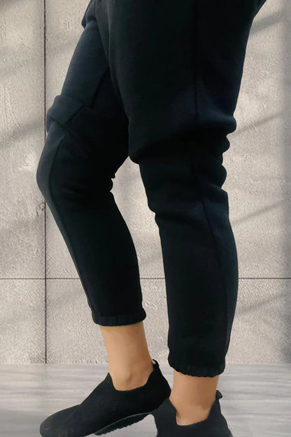 Bottom view of Women wearing Black jogger pants 