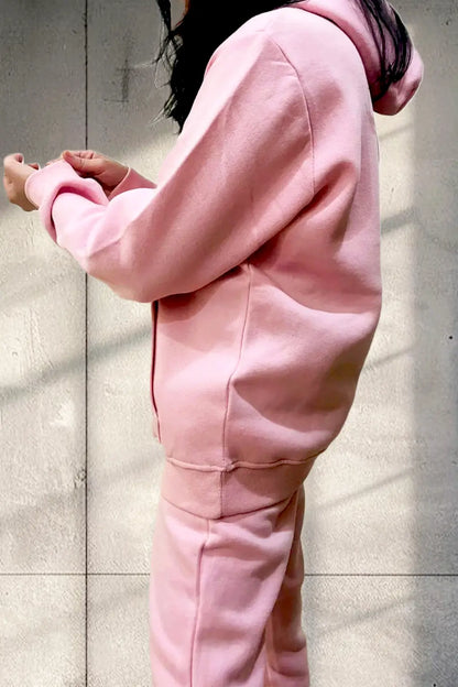 Side view of Women Wearing Hoodie and Jogger Pants in Fleece in a Studio