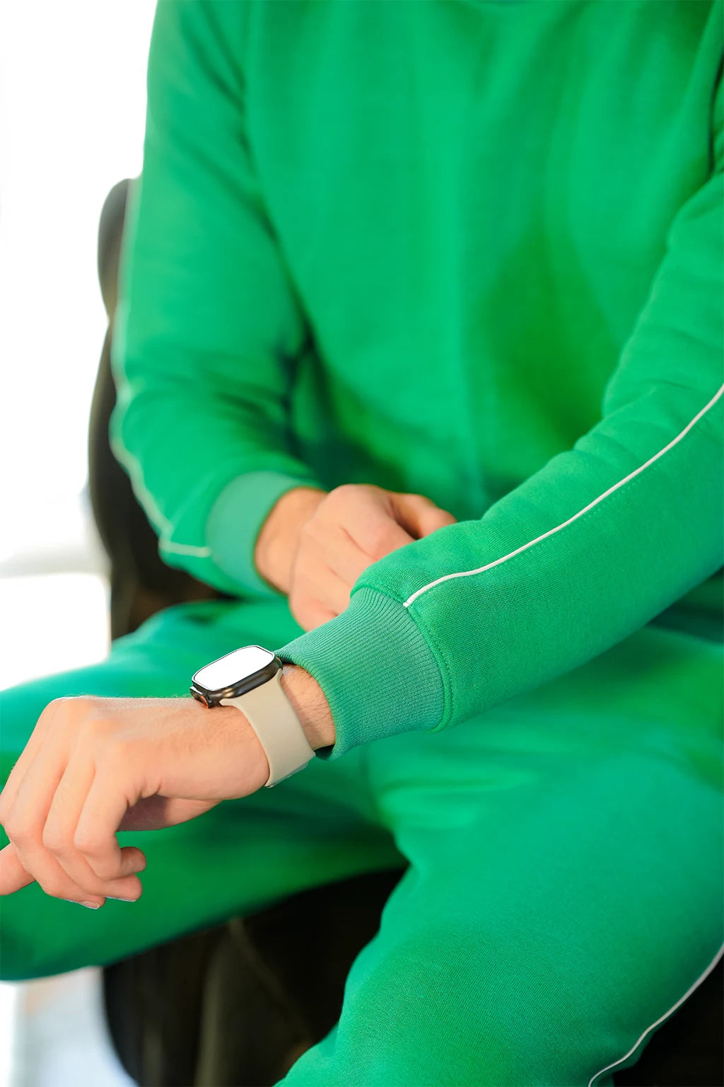 Close view of White sleeve Piping in green sweatshirt