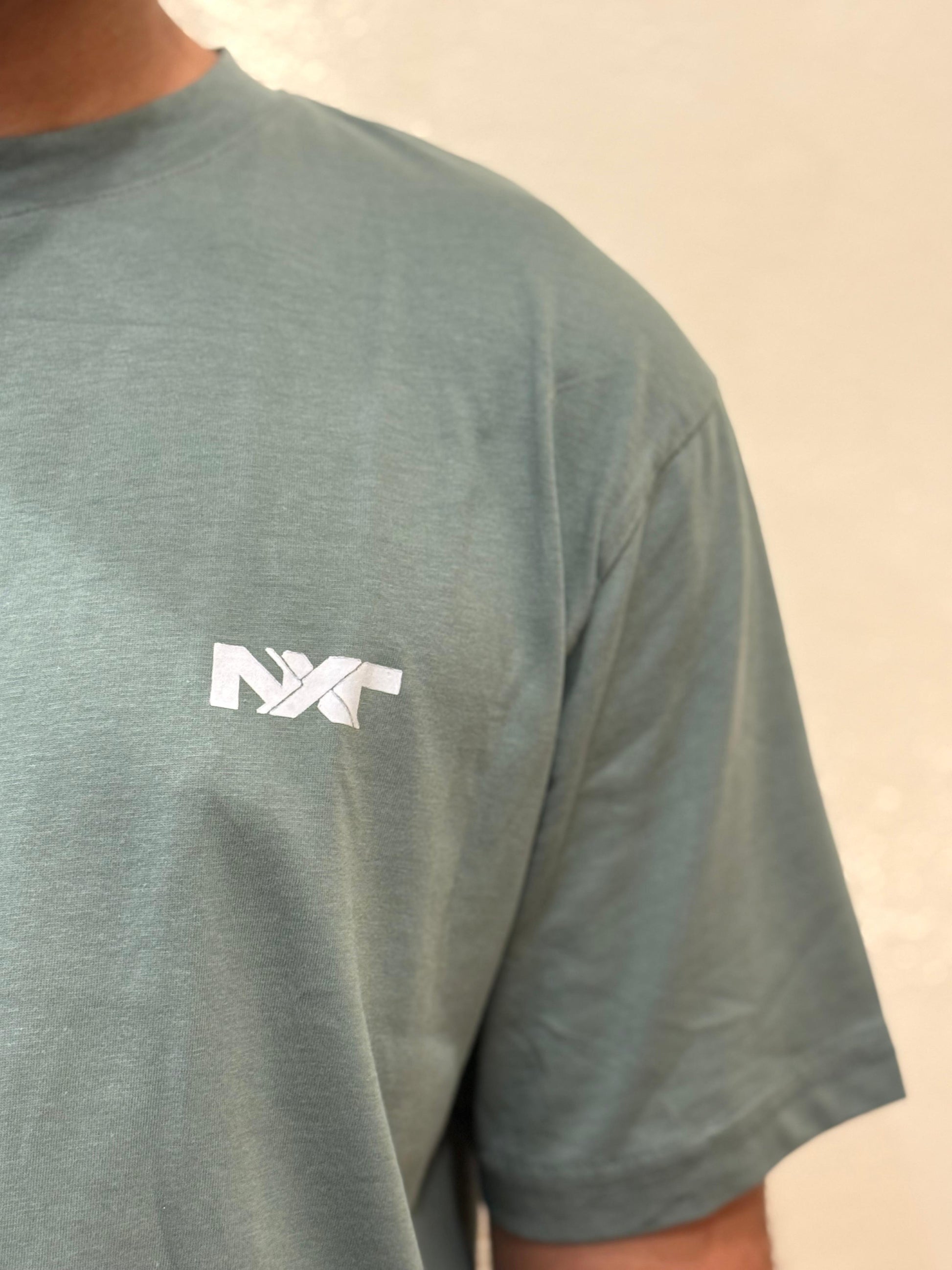 Close-up of fabric details on Nxtwears men’s green t-shirt and black shorts set