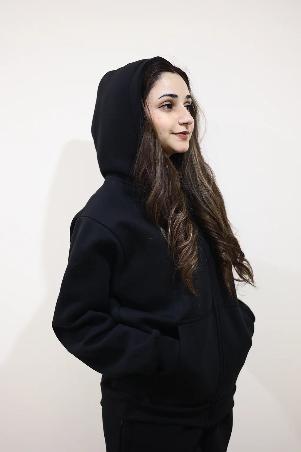 Model wearing Nxtwears unisex black zipper hoodie and trouser set with Cap on