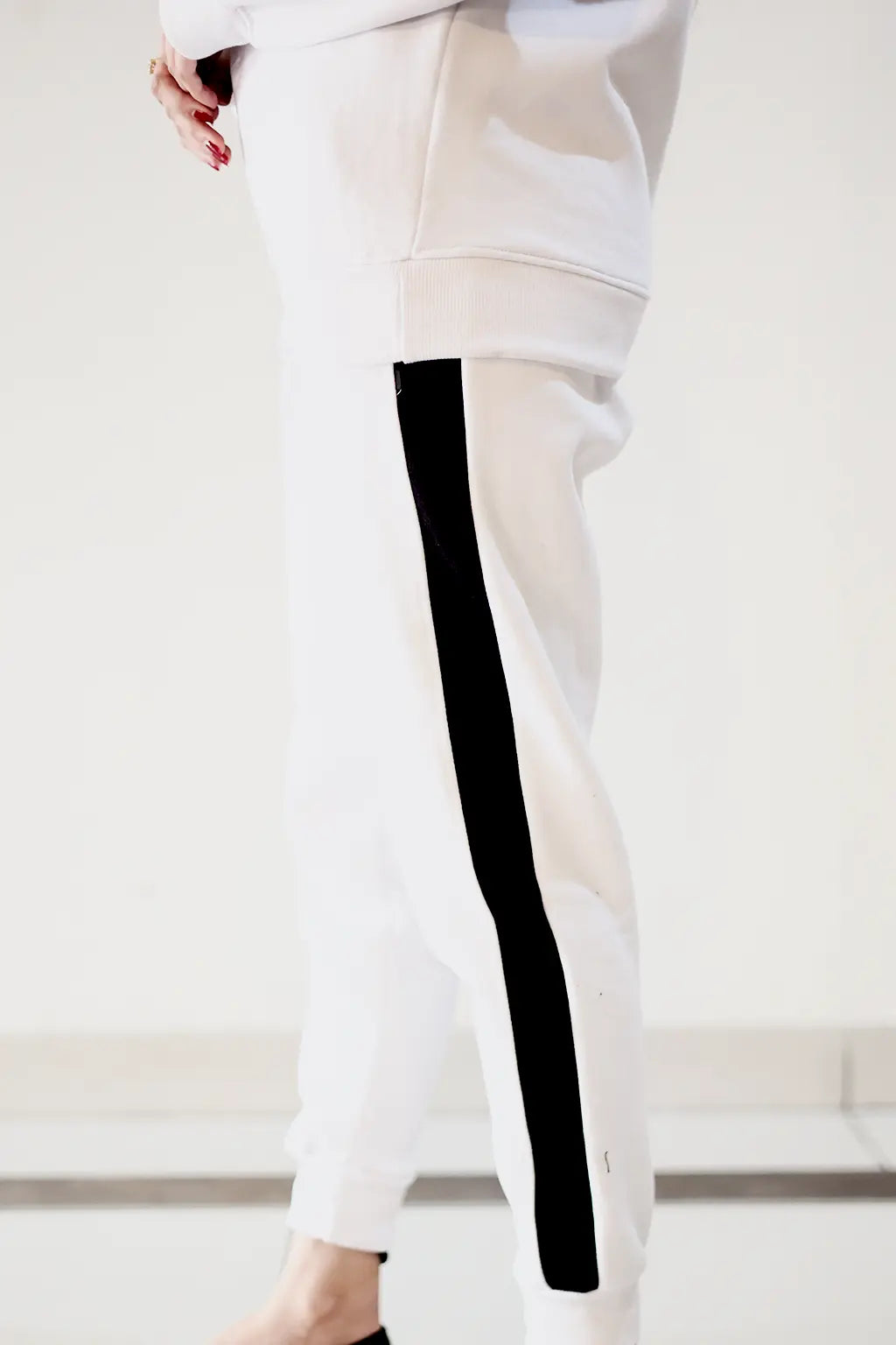 Close-up of black stripe border detailing on Nxtwears white unisex winter sweatsuit